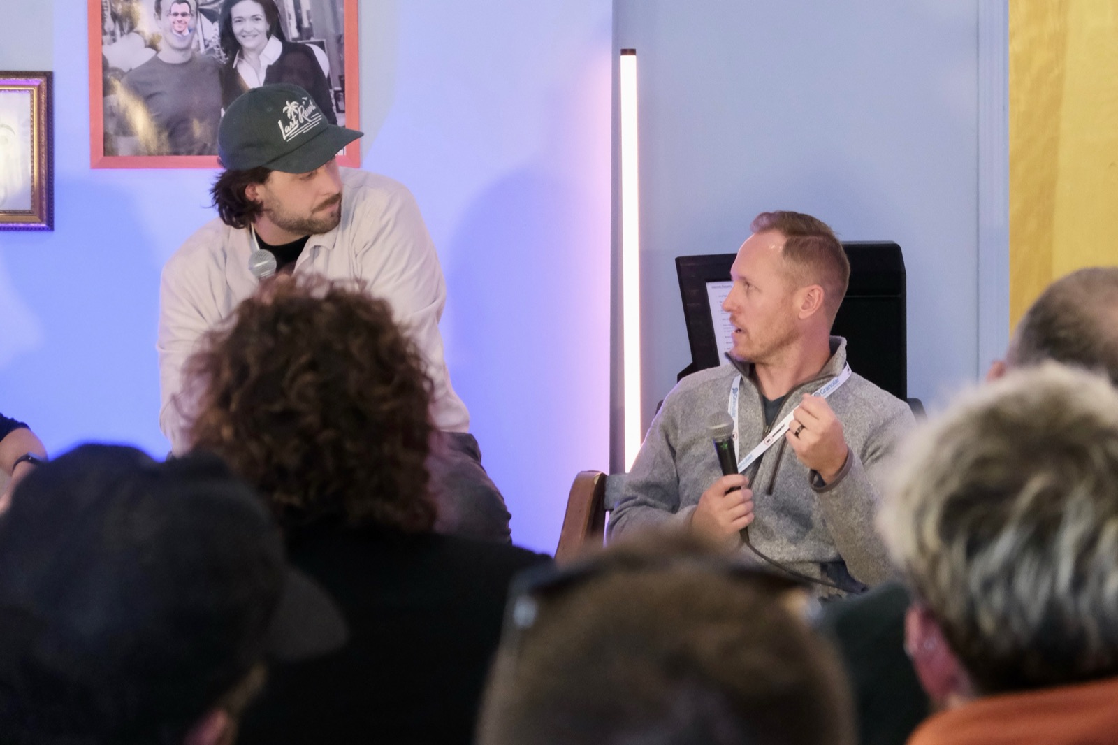 Kyle Faber, Head of SEO at Snark Digital, answers a question into a microphone as moderator Tyler Einberger turns toward him during the MKE DMC panel on AEO, GEO, and SEO