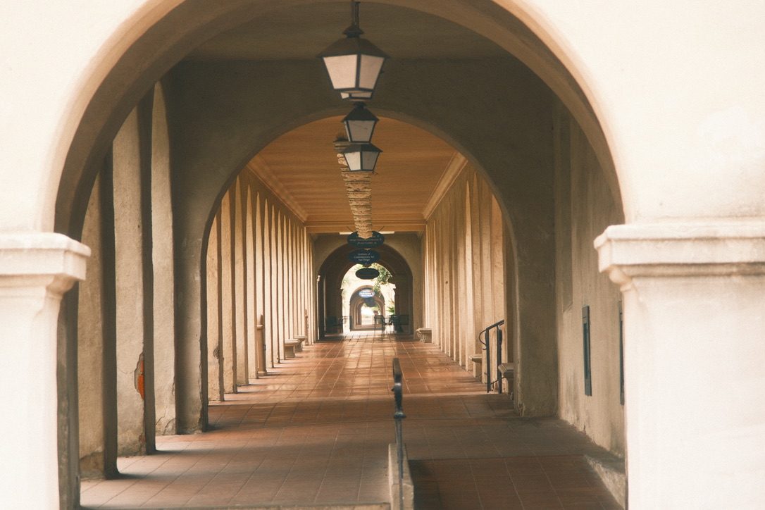 A covered arcade with hanging lanterns in Balboa Park, San Diego, photographed during Tyler Einberger's trip to brightonSEO San Diego 2026